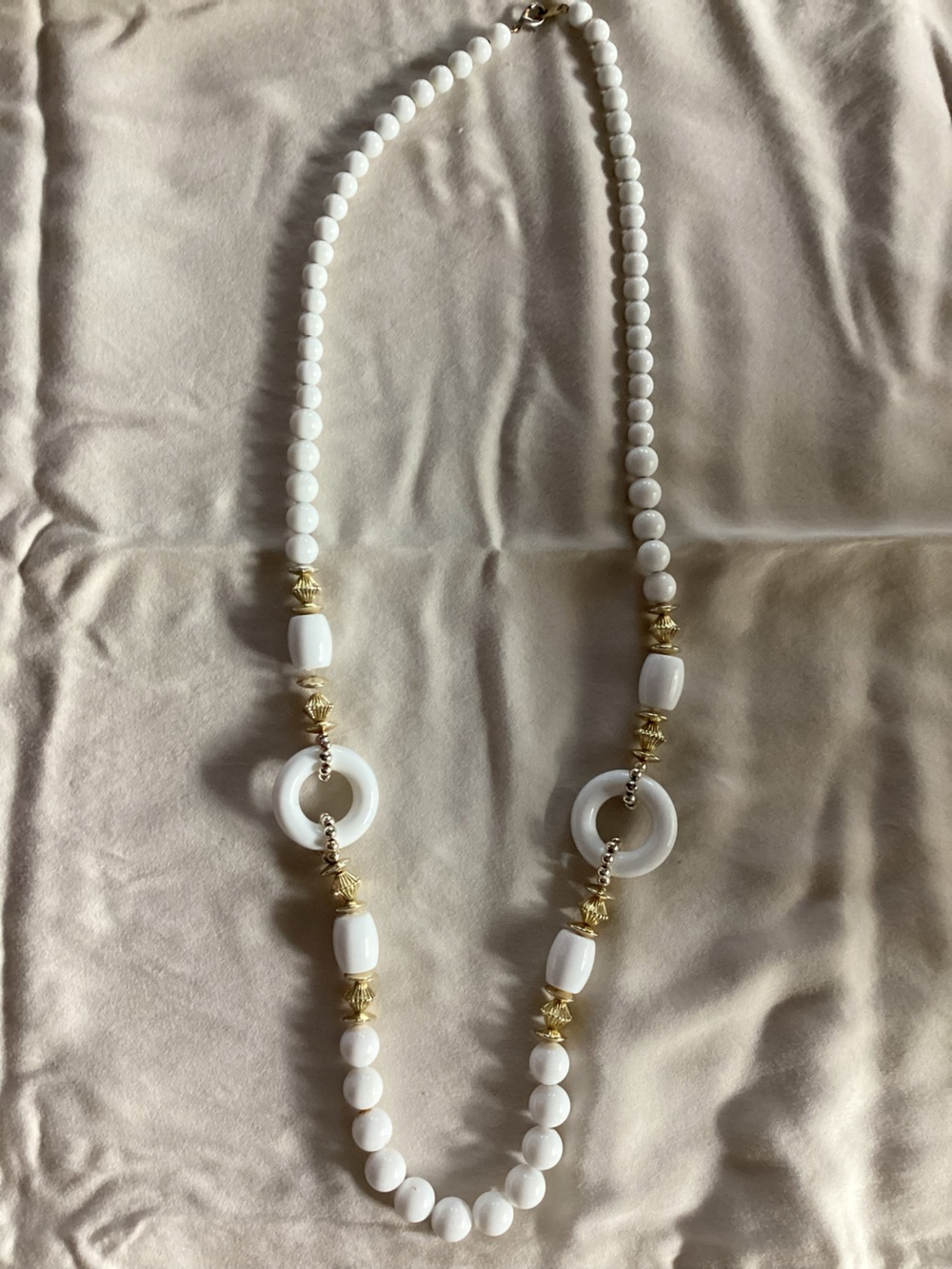 White necklace with gold Charms